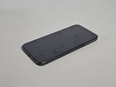 le dos d'un téléphone portable noir posé sur une table blanche