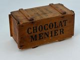 wooden box with chocolate menier written on it sitting on a white surface