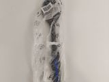 an image of a toothbrush wrapped in plastic on a white surface