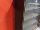 a picture of a glass display case in the corner of a room