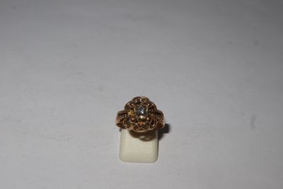 a close up of a gold ring with a diamond on it