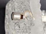 a close up of a piece of ice with a screw on it