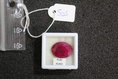 a small box with a red stone inside of it