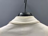a close up of a white shirt with a black collar