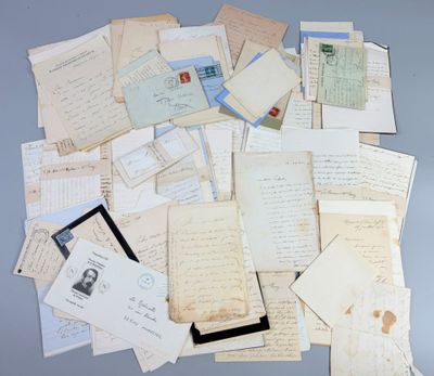 several old letters and envelopes are piled together on a table