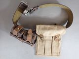a belt with two buckles attached to it on a white surface