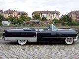a black and silver car parked on a brick road