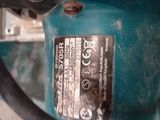 a close up of a blue machine with a black handle