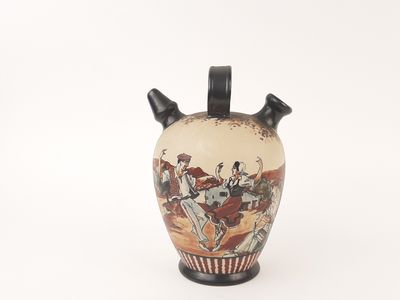 a vase with a painting on it sitting on a white surface