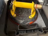 a black case with a yellow handle sitting on the floor