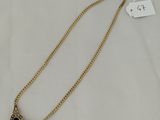a gold necklace with an evil eye charm on it