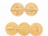 two gold coins and a pair of bobby pins