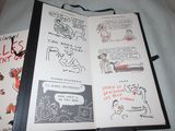 a book open on a bed with drawings on it