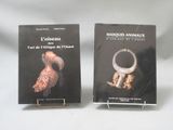 two books on a table with a white background and a black cover
