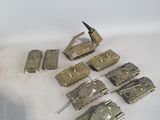 a lot of toy army tanks on a white surface