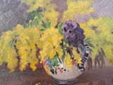 yellow and purple flowers in a white vase on a table