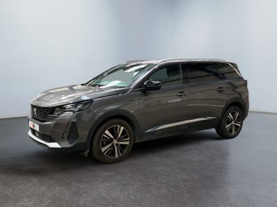 a grey suv parked in a room with a black floor
