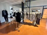 a clothing rack with clothes on it in a room
