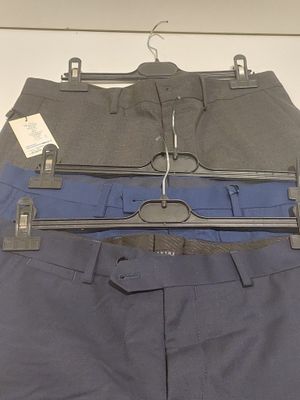 three pairs of pants hanging on a hanger