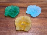 three pieces of glass sitting on a wooden table