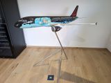 a model of a plane on a stand in a room