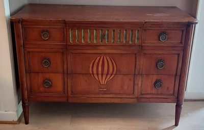 a wooden dresser with a mirror on top of it