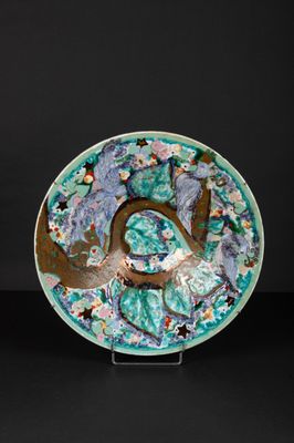 an image of a blue and green plate with flowers on it