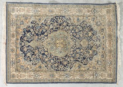 an antique persian rug with a medallion design on a blue ground