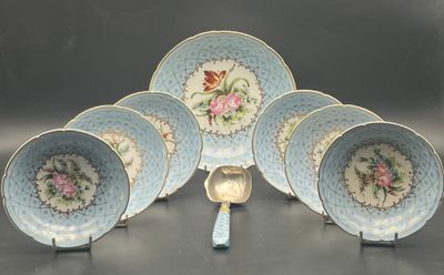 five blue and white plates and a spoon on a table