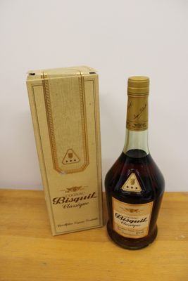 an image of a bottle of brandy sitting next to a cardboard box