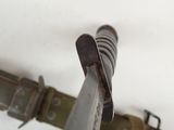 a close up of a knife with a handle on it