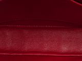 the inside of a red handbag with a gold handle