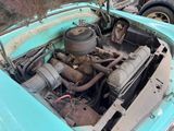 an old car with the engine in it ' s trunk