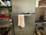 a large stainless steel refrigerator in the middle of a kitchen