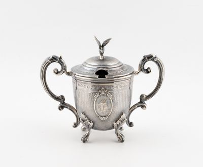 une théière ancienne en argent, à deux anses, surmontée d'un oiseau