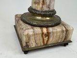 a marble pedestal with a candle on top of it