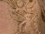 a close up of a statue of a woman with a bird on it ' s head