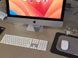 a desk with a computer, keyboard, mouse and mouse on it
