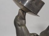a statue of a bird with a hat on its head