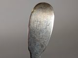 a silver spoon that has a word written on it