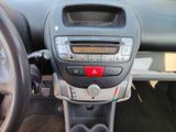 a dashboard of a car with a clock and a steering wheel