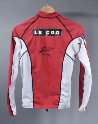 a close up of a red and white jacket hanging on a hanger