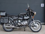 a black motorcycle parked in front of a garage door