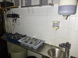a picture of a kitchen with a lot of utensils on the counter