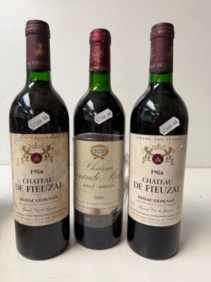 three bottles of wine sitting on top of a table next to each other