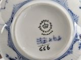 a blue and white plate with a crown on it