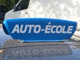 a blue sign on the roof of a car that says auto - eole
