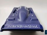 a blue car that is sitting on a white surface