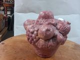 a pink vase sitting on top of a wooden table