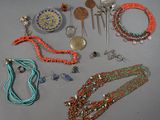 several necklaces and bracelets are arranged on a gray surface
